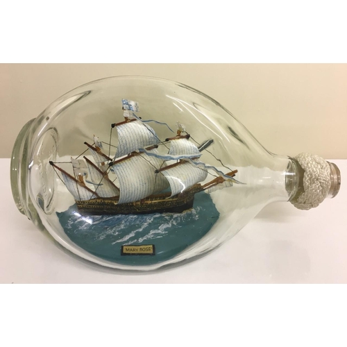 230G - Two model ships in bottles.
A glass model of HMS Victory with display stand, together with a wooden ... 