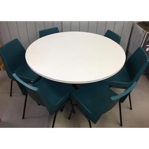 15 - A retro, white, circular dining table, together with six (stacking), aqua-coloured, moulded dining c... 