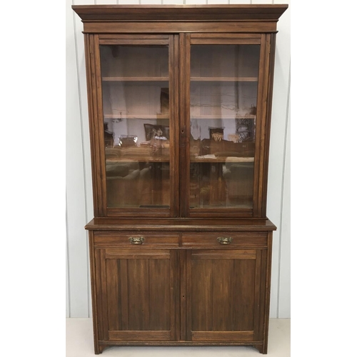 43 - A tall, Edwardian Library Bookcase. Three-shelved, glazed cupboard over two drawers, over twin cupbo... 
