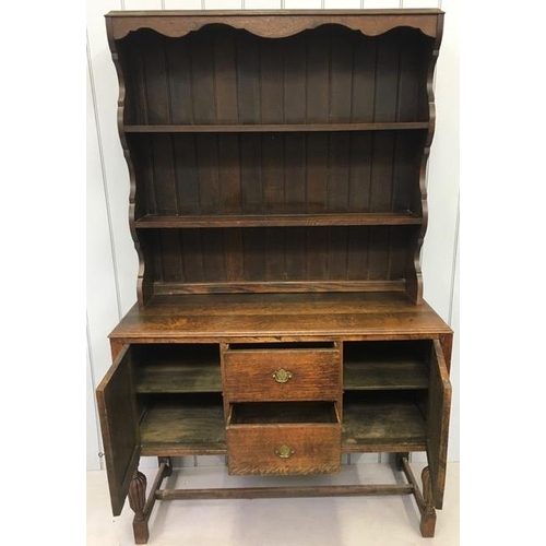 44A - Oak Dresser. Two shelved plate rack over two-door cupboard, aside central two drawers. Stretchered l... 