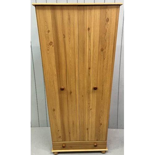 60 - A pine coloured double wardrobe. Single floor level drawer and a hanging rail.
Dimensions(cm): H191 ... 