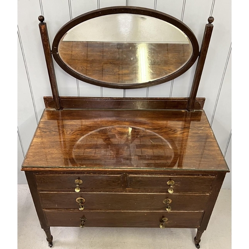 68 - A vintage dressing table. Two over three drawers, with oval swing mirror. Brass handles & castors. G... 