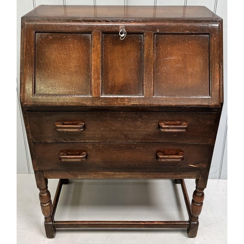 108 - A vintage oak bureau. Drop-front over two drawers. Dimensions(cm) H107, W77, D42.