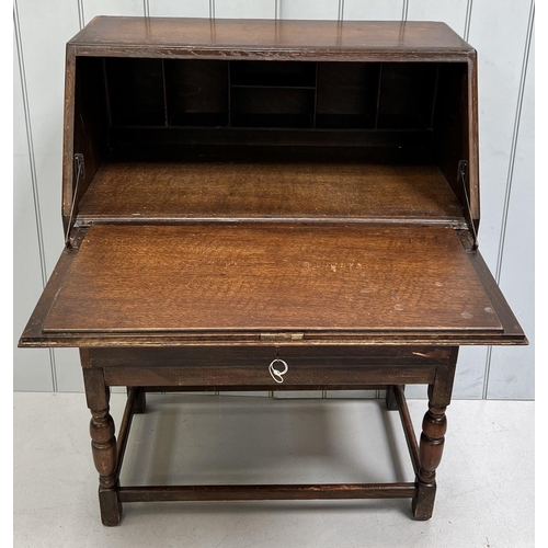 108 - A vintage oak bureau. Drop-front over two drawers. Dimensions(cm) H107, W77, D42.