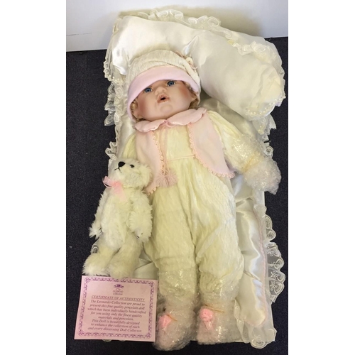 1826 - The Leonardo Collection Baby doll, with bear. Certificate of authenticity included. Height 49cm.