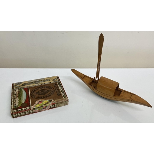 647 - A vintage 'Dannemann & Co' cigar box, together with a bamboo model boat.