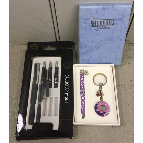 655 - A Shudehill gift set, pen and keyring set, together with a calligraphy set.