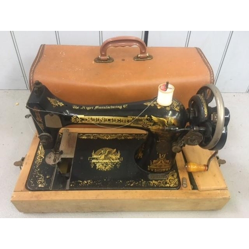 656 - An early model 127K Singer Sewing Machine. Complete with original case, manual & accessories. Manufa... 