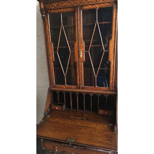 39 - An Edwardian bureau bookcase. Glazed/shelved cupboard over fall front fitted desk area, on barley-tw... 