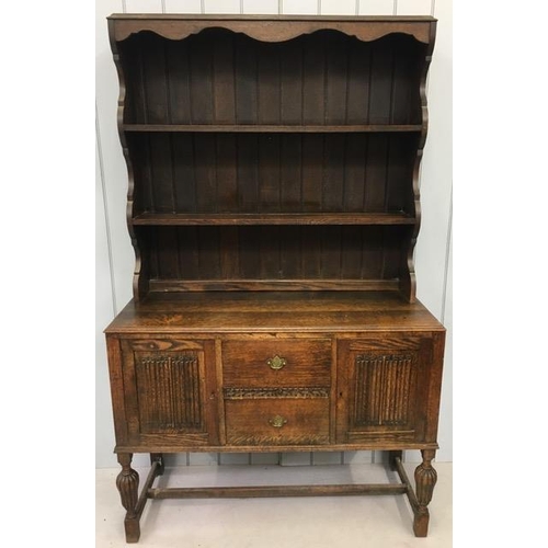 44A - Oak Dresser. Two shelved plate rack over two-door cupboard, aside central two drawers. Stretchered l... 