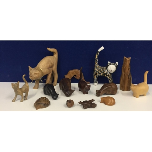 661F - A collection of fourteen animal figures, mainly cats. Material bog yew, blackwood, coco bolo etc.