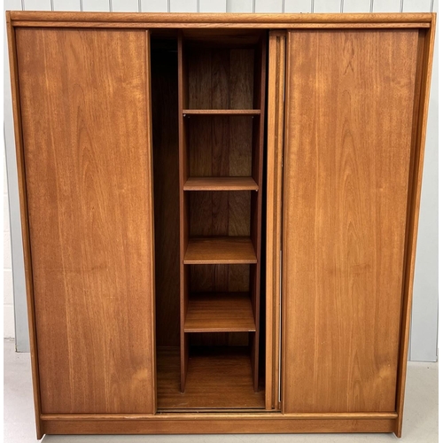 119B - A mid-century, teak, triple wardrobe, by Austinsuite.
Three sliding doors (one mirrored). Two single... 