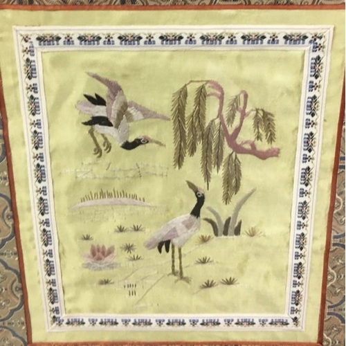 366 - Two framed oriental silks, together with a pair of framed lace flowers.