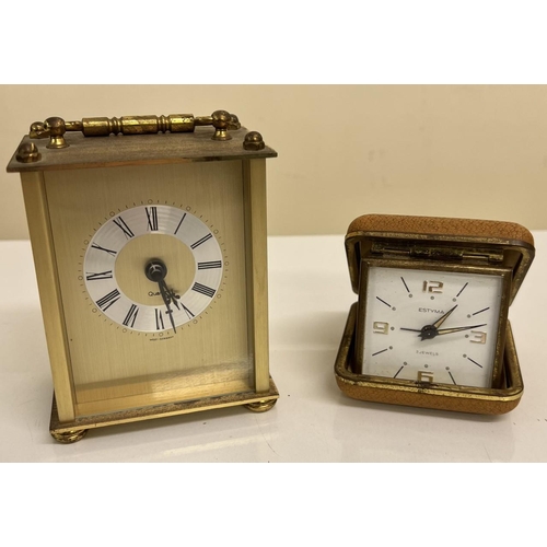 407 - A vintage, Quartz West German carriage clock, together with a travel alarm clock made by 'Estyma'.