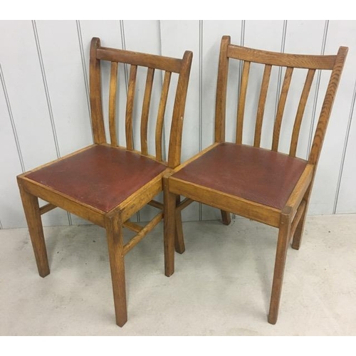 150 - A pair of oak/vinyl dining chairs. Dimensions(cm) H86(45 to seat), W43, D37.