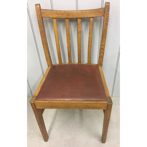 150 - A pair of oak/vinyl dining chairs. Dimensions(cm) H86(45 to seat), W43, D37.