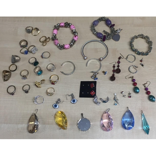 412 - A selection of bangles, rings, earrings & pendants.