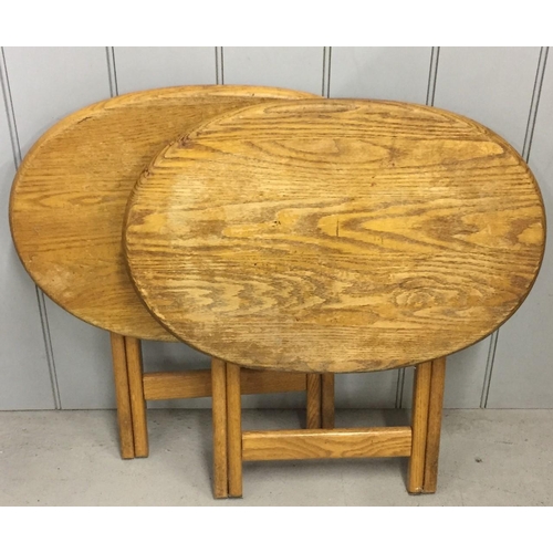 24 - A pair of oak, folding tables. Dimensions(cm) H54, W60, D40.