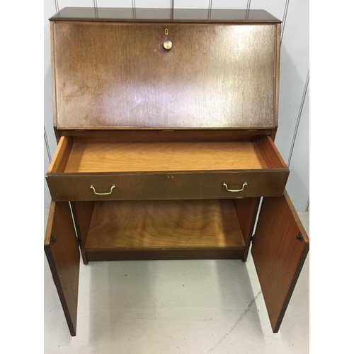 107 - A vintage 1950's bureau. Fall front desk area, with single drawer & double-door cupboard. Dimensions... 