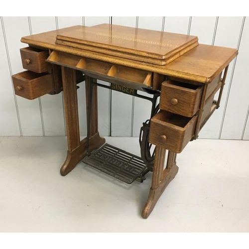 87 - A Singer treadle sewing machine table with sewing machine, accessories & original instruction manual... 