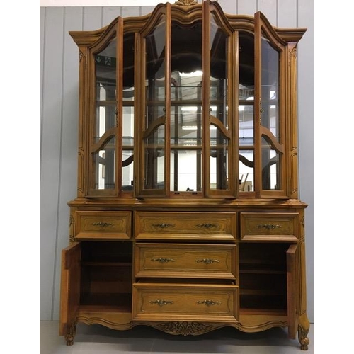 35 - A large, walnut-veneered display cabinet. Glazed/shelved cupboard over five drawers/double cupboard ... 