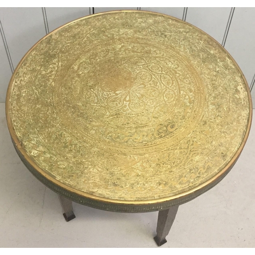 17 - A vintage brass-topped occasional table. Dimensions(cm) H55, W60, D60.