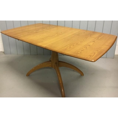 117 - An Ercol Windsor, extending pedestal dining table. Extension leaf housed on mechanism beneath table ... 