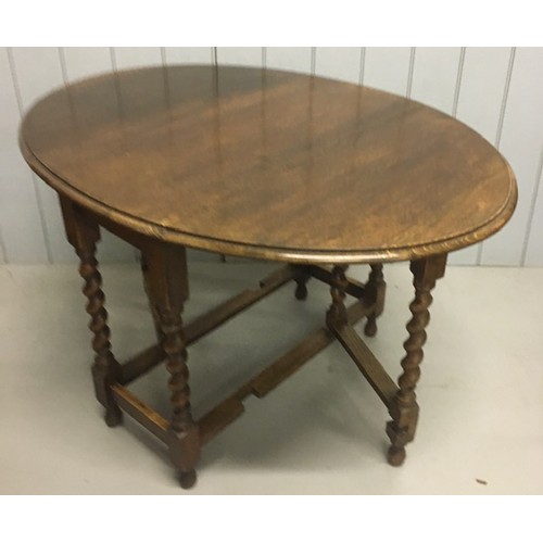 1 - An Edwardian oak gateleg table, with barley twist legs. Dimensions(cm) H74, W40/117, D90.