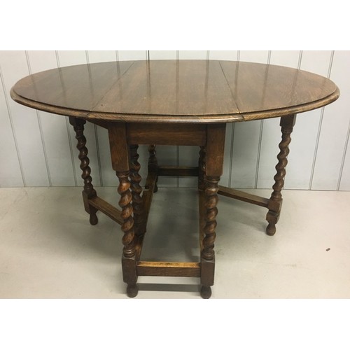 1 - An Edwardian oak gateleg table, with barley twist legs. Dimensions(cm) H74, W40/117, D90.