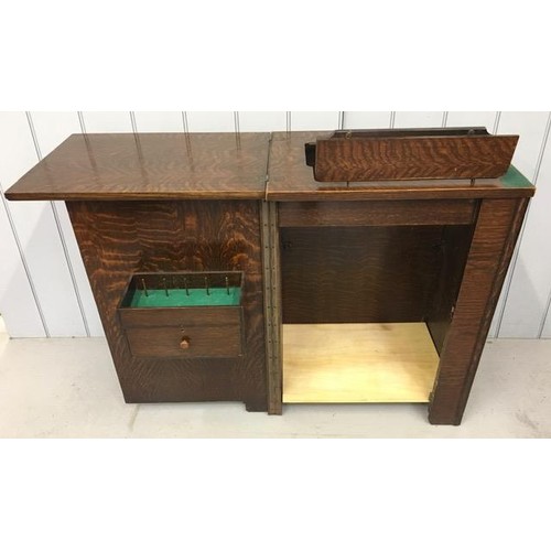 23C - An antique sewing machine cabinet.
Dimensions(cm) H79, W56/113, D42.