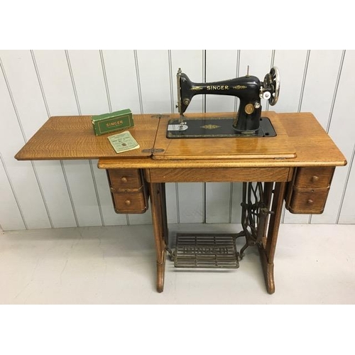 87 - A Singer treadle sewing machine table with sewing machine, accessories & original instruction manual... 