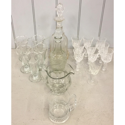 202 - A mixed lot of vintage glassware. Includes two cut glass decanters, water jug & a quantity of crysta... 