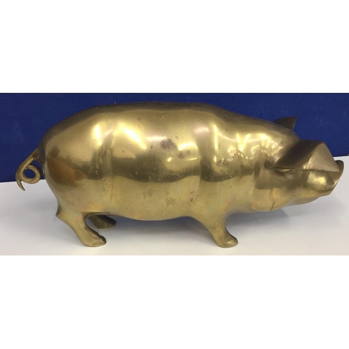 455 - A vintage brass model pig. Height 16cm, length 38cm.