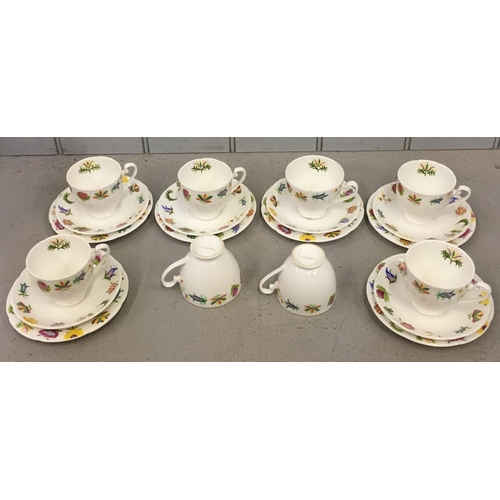 502 - A unique, hand painted teaset. Comprises of eight teacups, six saucers & six side plates. Painted by... 