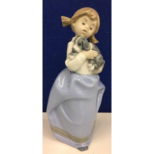 558 - A Lladro NAO Girl with Puppy figurine. Height 20cm.