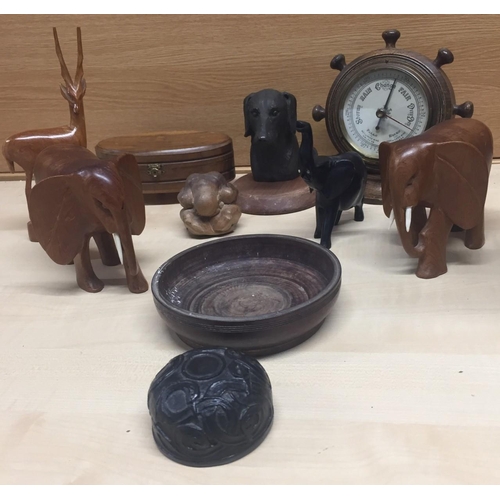 661B - A selection of ten mid century wooden ornaments. Includes elephants, ship's wheel barometer, trinket... 