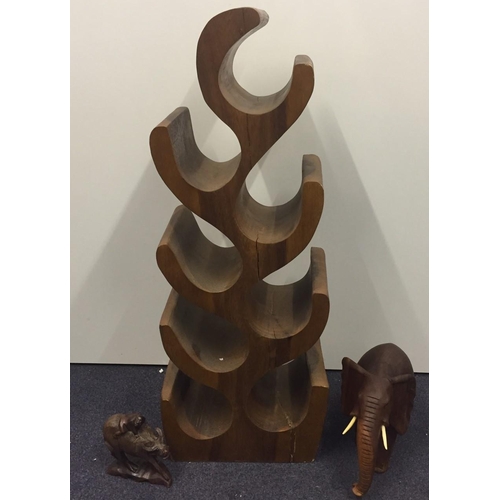 686 - A carved wine rack (Height 70cm, width 28cm), together with two vintage animal carvings.