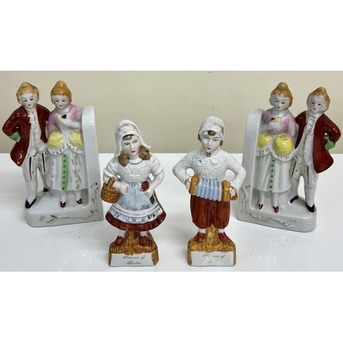 552 - A pair of ceramic bookends together with a pair of ceramic figurines.