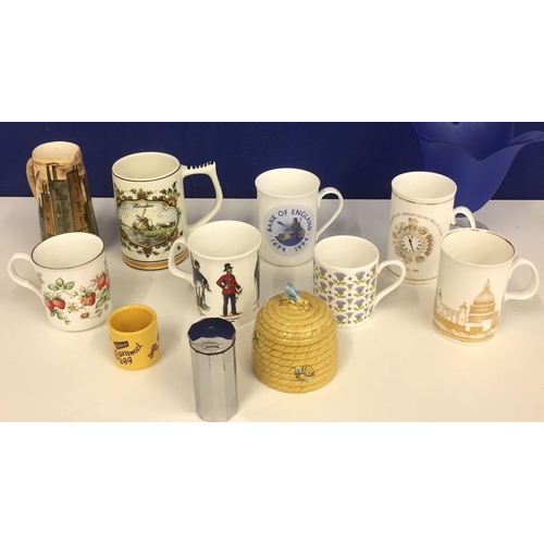 576 - A collection of seven mugs, including Bank of England, London Skyline, Heineken, a Lauriana Studio j... 