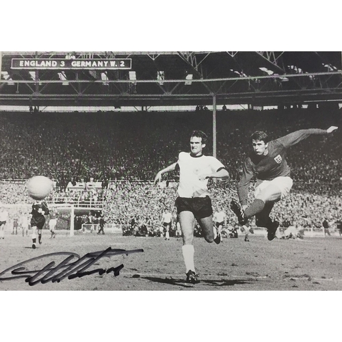 1694 - A signed photo of Geoff Hurst's famous 1966 world cup goal, together with a colour team photo & home... 