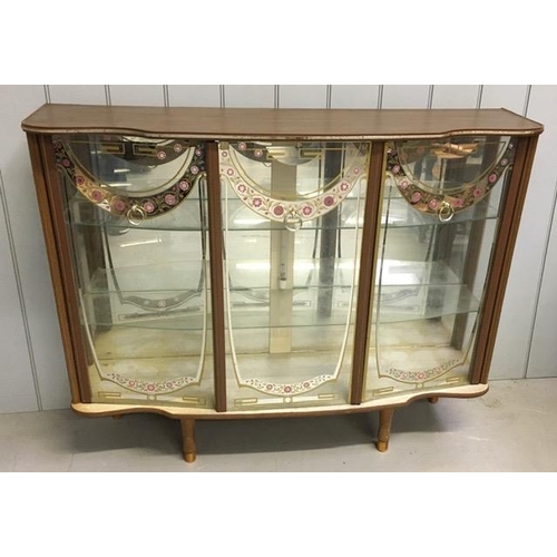 119 - A charming, mid-century glazed cocktail/display cabinet. Three glazed/patterned doors, with two inte... 