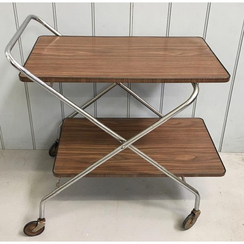 125 - A mid-century folding tea-trolley. Melamine trays, chrome frame on original castors. Dimensions(cm) ... 