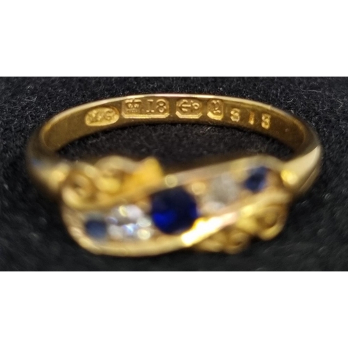 409 - An attractive late Victorian five stone diamond and sapphire ring. Two clean diamonds (approx. 0.08c... 