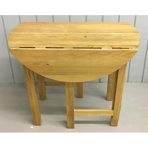 11 - A contemporary, beech, gateleg/drop leaf kitchen table. Dimensions(cm) H76, W90, D46/90.