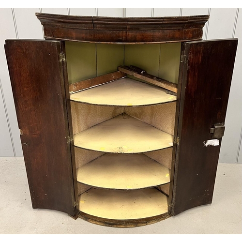 84 - An antique, mahogany, wall-hanging corner cabinet. Dimensions(cm) H104, W70, D46.