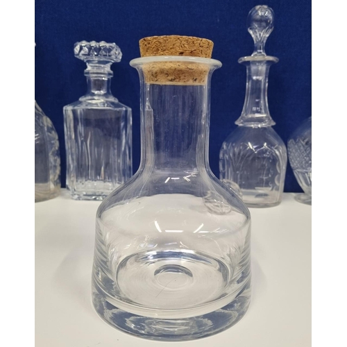 206D - An assortment of glass & crystal decanters, with a spare stopper. To include an attractive, plain cr... 