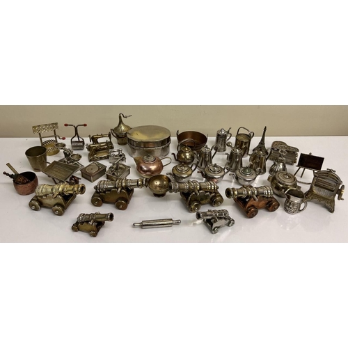 465A - A collection of miniature metal items, consisting of brass and copper. Items include cannons, rollin... 