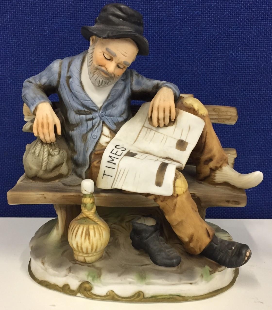 A 'Marks and Rosenfeld' figurine of an old man on bench with The