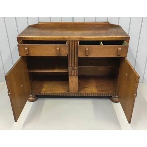 49 - An Edwardian oak buffet sideboard. Twin drawers over double cupboard. Dimensions(cm) H89, W120, D46.