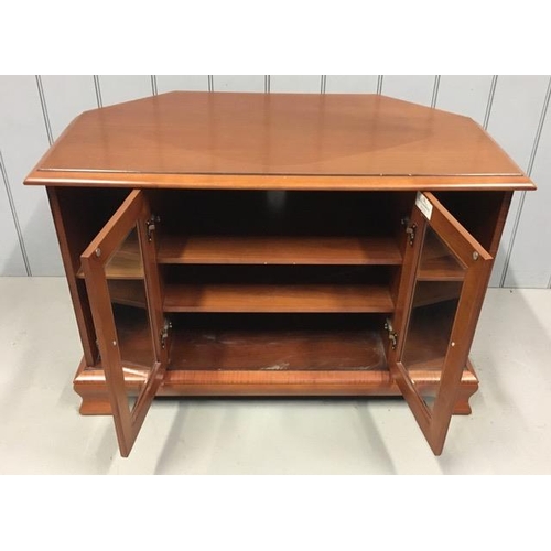 106 - A cherry-coloured, corner TV stand, by White & Newton. Features glazed doors, with two media shelves... 